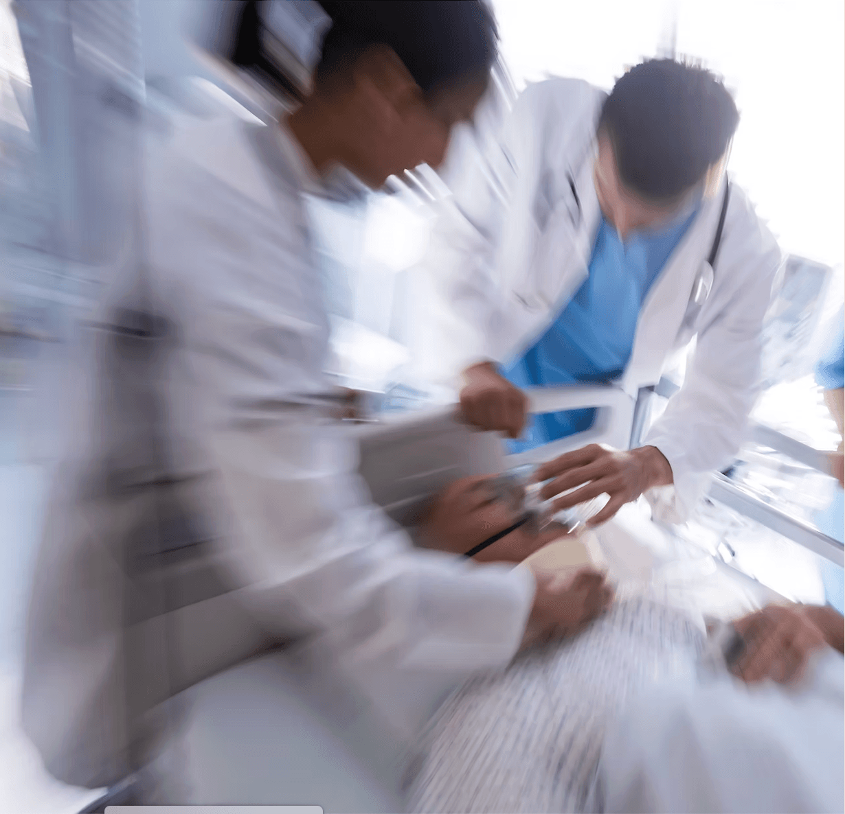 Clinical team in motion — nurses providing urgent patient care at the bedside